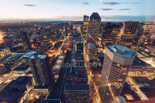 View from height of modern city infrastructure with towers of skyscrapers under blue dusk sky, Canada — Stock Photo