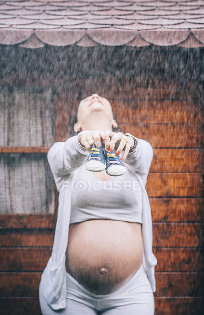 Belle femme enceinte posant sous la pluie — Photo de stock