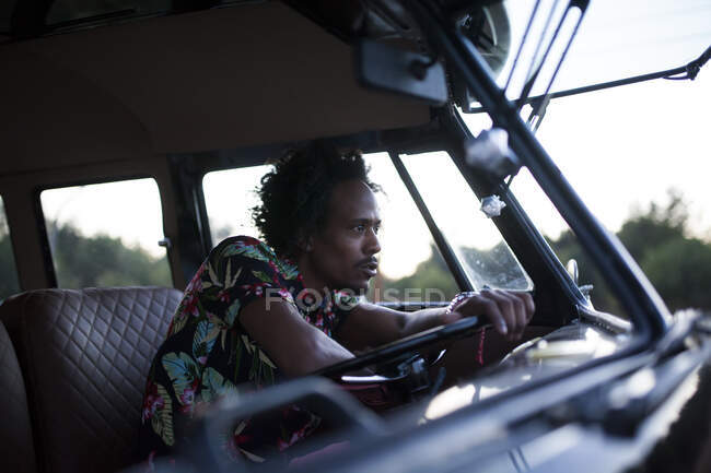 Beautiful afro man enjoys the trip in her vintage van with some friends — Stock Photo