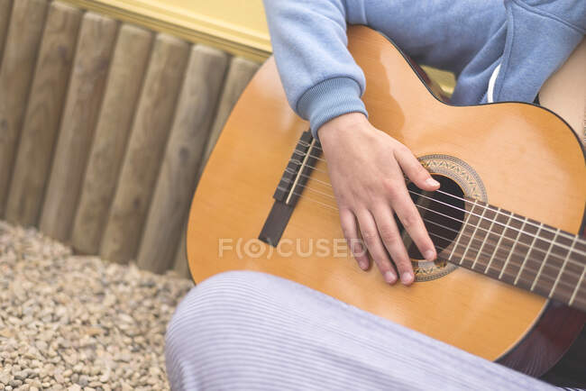 Vista de la mujer tocando la guitarra - foto de stock