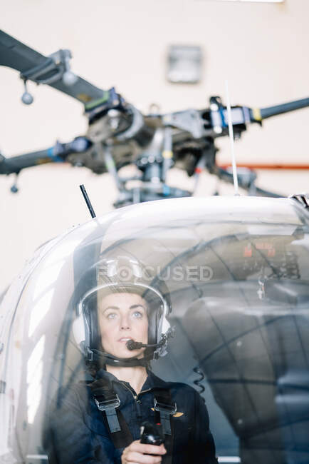 Pilot girl inside her helicopter. — Stock Photo