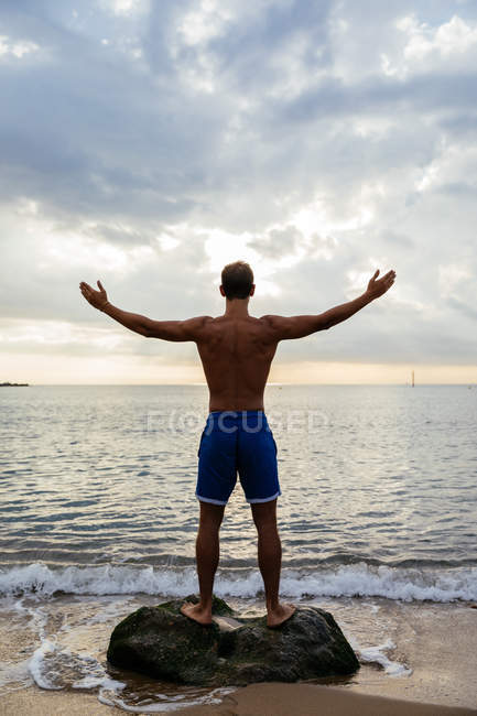Молодой спортсмен позирует у моря — стоковое фото