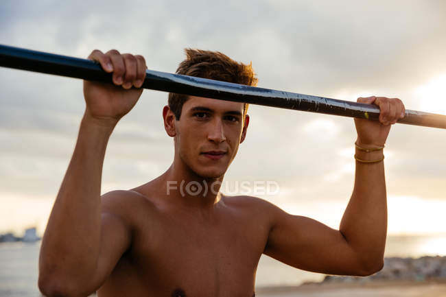 Junger Mann trainiert außen am Barren — Stockfoto