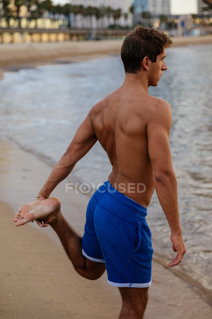 Male athlete doing stretching outside — Stock Photo