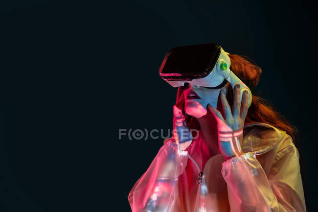 Woman wearing VR glasses in neon light — Stock Photo
