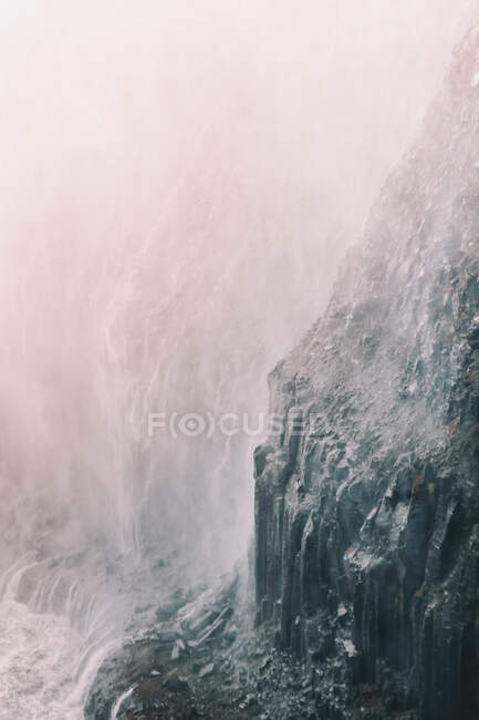 View of hard rocky cliff surface in mist and haze — Stock Photo