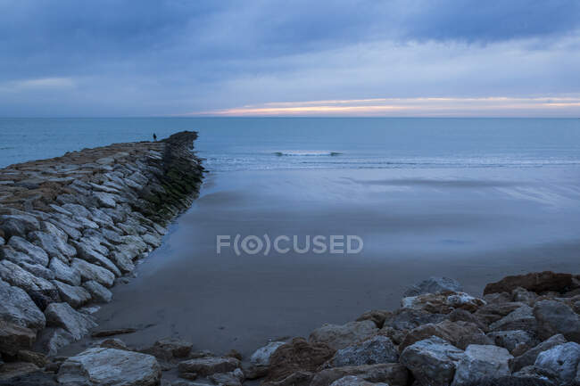 Breakwater facing the sea at sunset south of Spain — Stock Photo