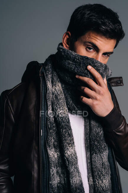 Young attractive brunet man in a studio — Stock Photo