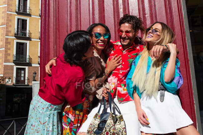 Stylish friends embracing on street — Stock Photo
