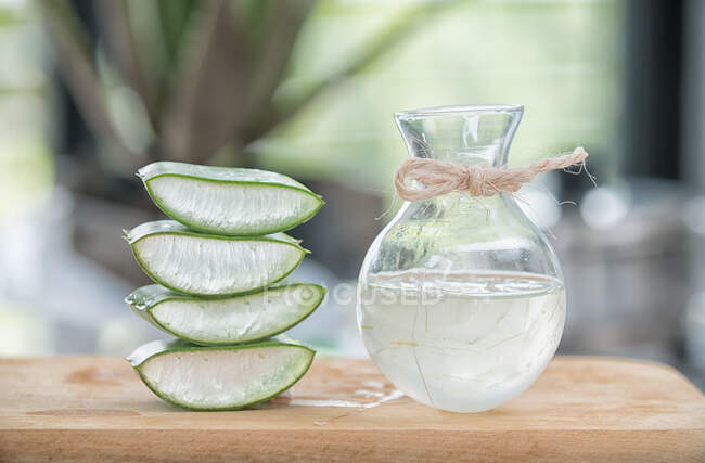 Pieces of Aloe Vera and refreshing drink served in glass jug on the table. — Stock Photo