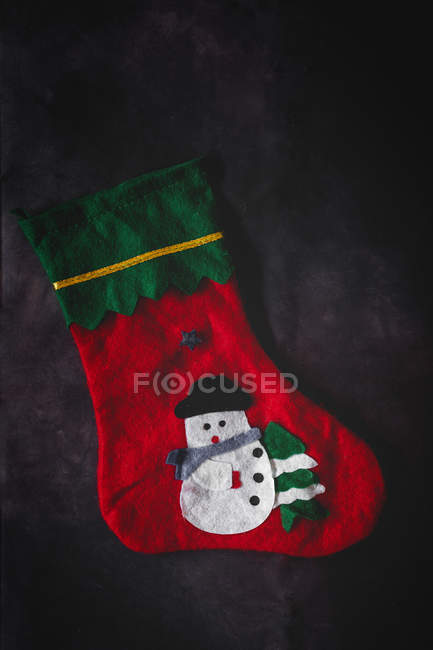 Colorful decorated Christmas sock on dark background — Stock Photo