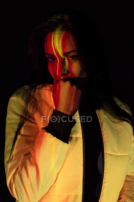 Pretty young woman in white jacket with light stains on face looking at camera — Stock Photo