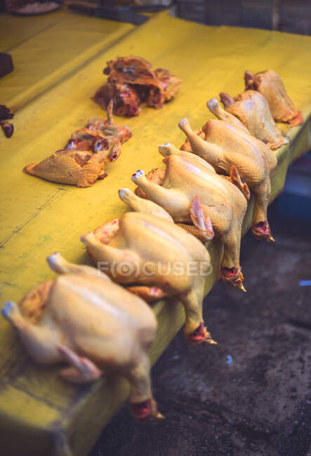 Ein Bündel frisch gerupfter Hühner liegt auf einem gelben Marktstand in San Cristobal de las Casas in Chiapas, Mexiko — Stockfoto
