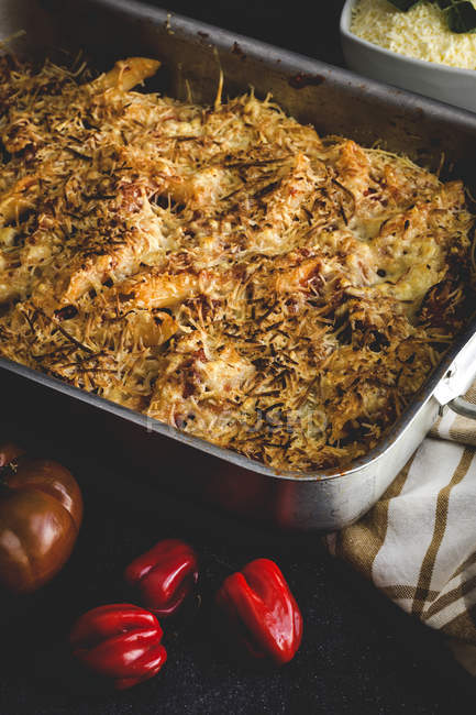Baked macaroni with cheese and chorizo in baking pan — Stock Photo