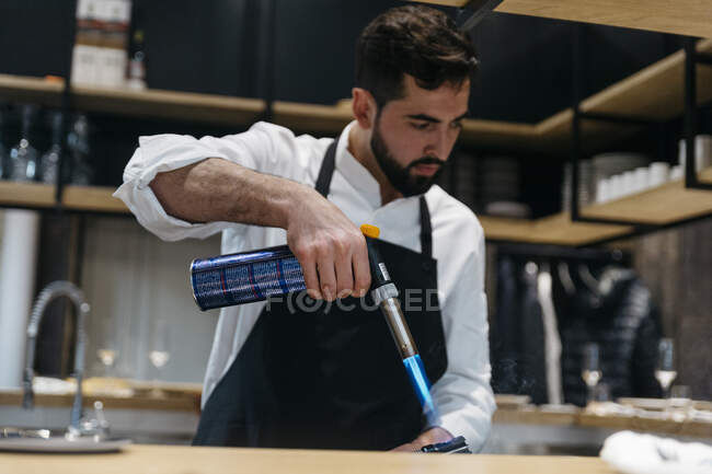 Chef cooking in restaurant with torch — Stock Photo
