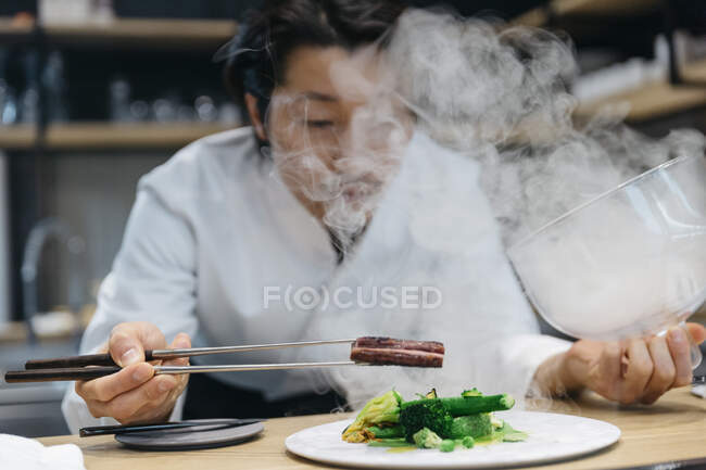 Шеф-кухар готує в ресторані з чашкою диму — стокове фото