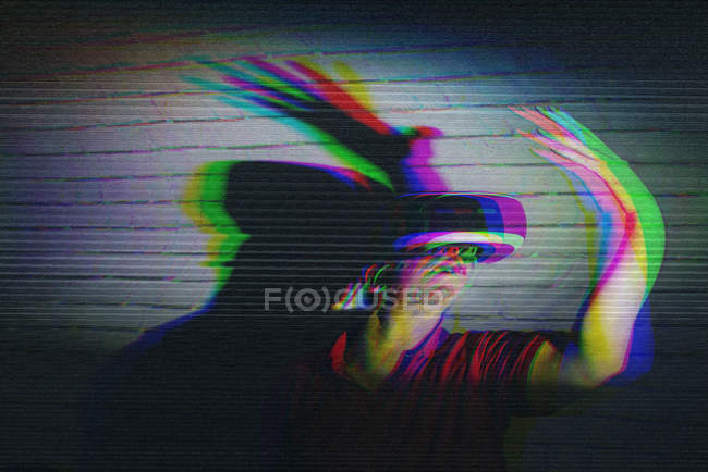 Man testing VR glasses on dark background — Stock Photo