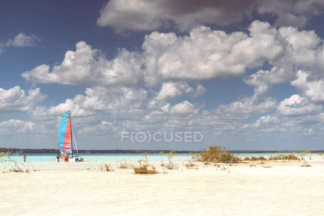 Group of people sailing small boat while resting in Mexican Caribbean on cloudy day — Stock Photo