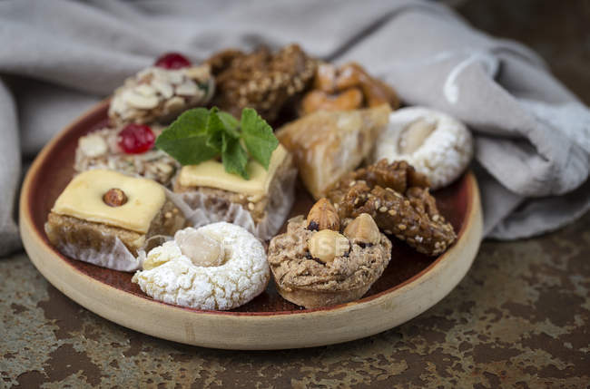 Типичные марокканские сладости с медом и миндалем на деревянном блюде — стоковое фото
