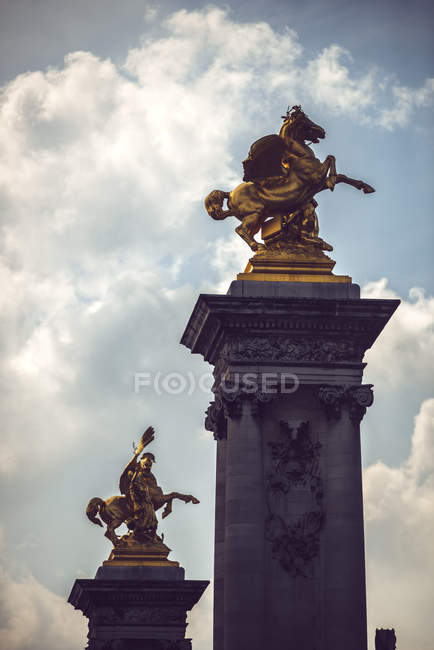 Columns on Alexander III bridge with gold covered statues of horse, Paris, France — Stock Photo
