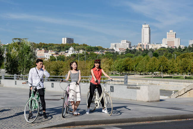 Asian people with bicycles — Stock Photo