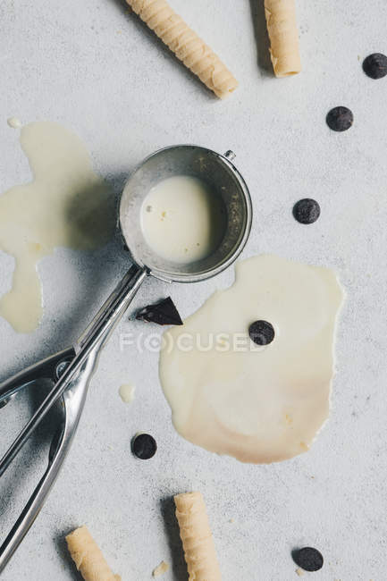 Melted vanilla ice cream in silver spoon — Stock Photo