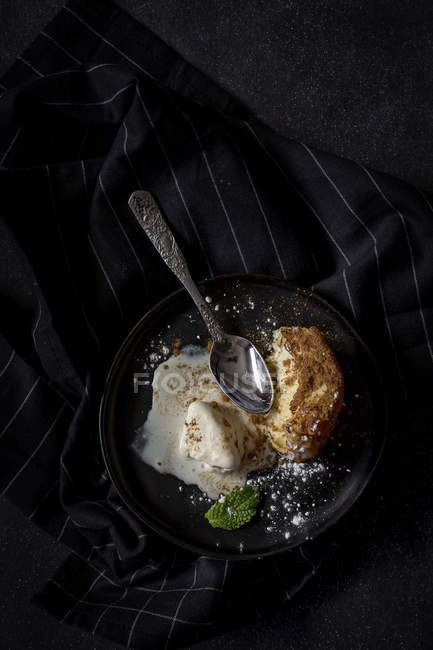 French toast with vanilla ice cream, cinnamon and mint on black plate — Stock Photo