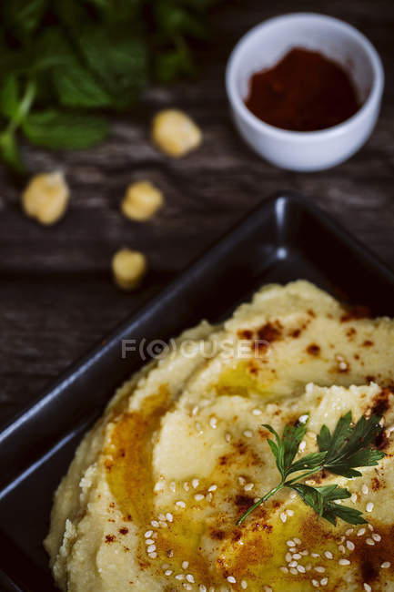 Close-up of homemade chickpea humus and garnished with parsley — Stock Photo