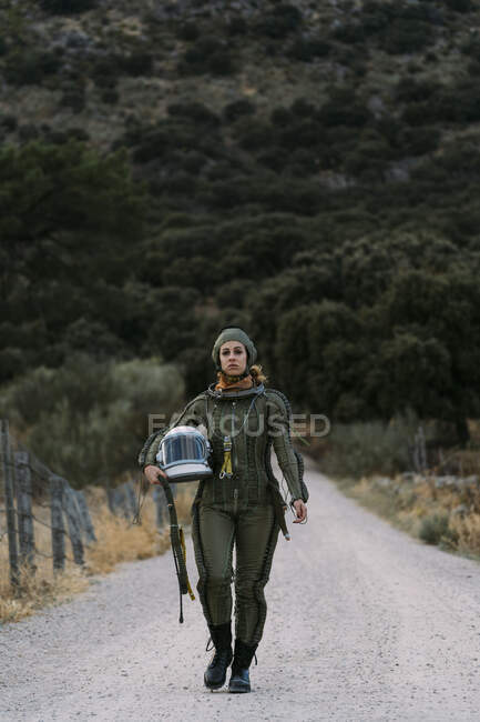 Beautiful woman walking dressed as an astronaut. — Stock Photo