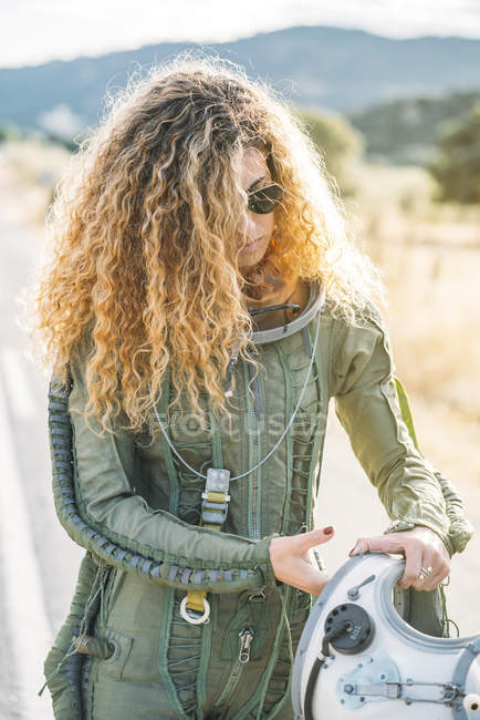 Young woman with curly hair wearing astronaut costume — Stock Photo
