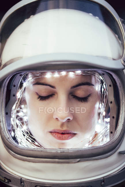 Close-up of girl wearing old space helmet with illumination — Stock Photo
