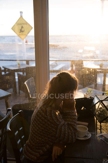 Woman looking out through the window — Stock Photo