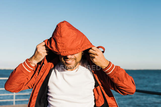 Cheerful man putting the hook on pier — Stock Photo