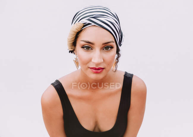 Young woman in kerchief on head standing on rooftop — Stock Photo