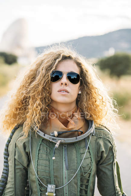 Portrait of female astronaut in spacesuit standing outdoors — Stock Photo