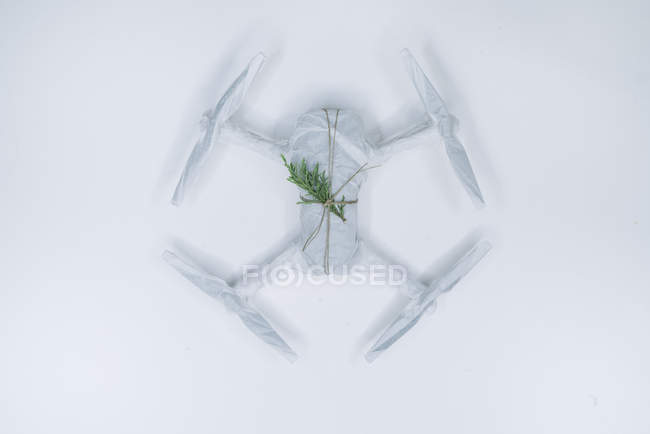 Drone wrapped as Christmas gift with fir branch on white background — Stock Photo