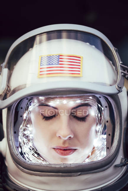 Close-up of girl wearing old space helmet with illumination — Stock Photo