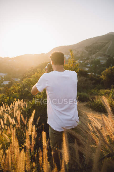 Мужчина фотографирует в красивой сельской местности — стоковое фото
