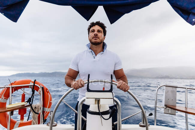 Captain of a ship sailing on a sailboat — Stock Photo