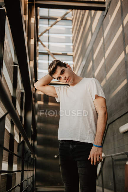 Portrait of young handsome man in t-shirt looking at camera — Stock Photo