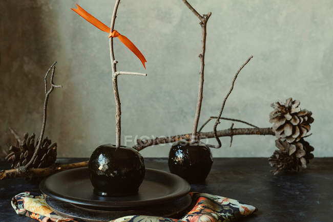Schwarze Karamelläpfel mit Stäbchen für Halloween — Stockfoto