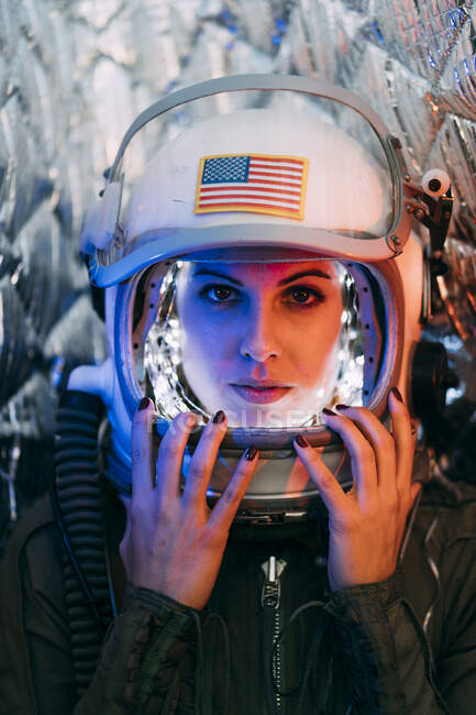 Beautiful woman poses looking at camera dressed as an astronaut. — Stock Photo