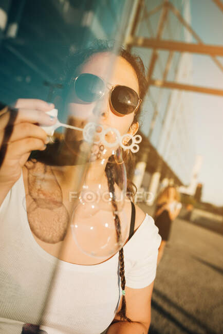 Young woman blowing bubbles — Stock Photo