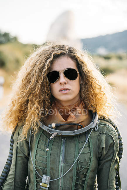Portrait of female astronaut in spacesuit standing outdoors — Stock Photo