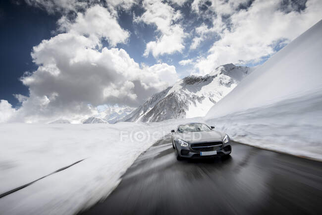 Moving car in mountain road in Alps — Stock Photo