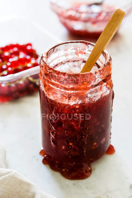 Glass jar of jam on white background — Stock Photo