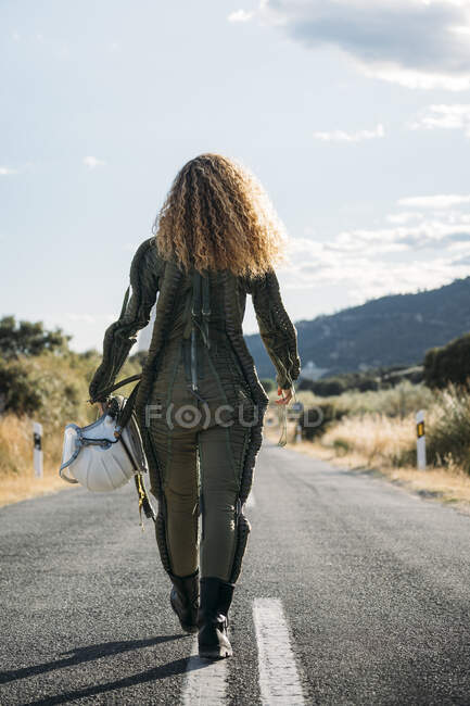 Beautiful woman walking dressed as an astronaut. — Stock Photo