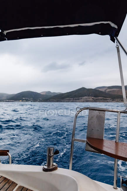 Detail of sailboat on high seas under cloudy sky — Stock Photo