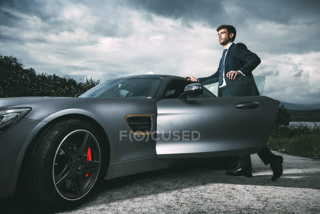 Business man in luxury car — Stock Photo