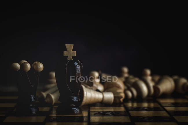 Close up of Game and chess pieces on dark background — Stock Photo